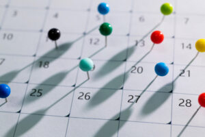 Colored pins on the calendar.